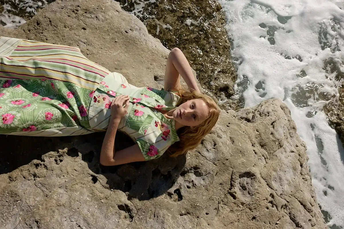 Floral print summer dress with green and pink hues, made of lightweight fabric.